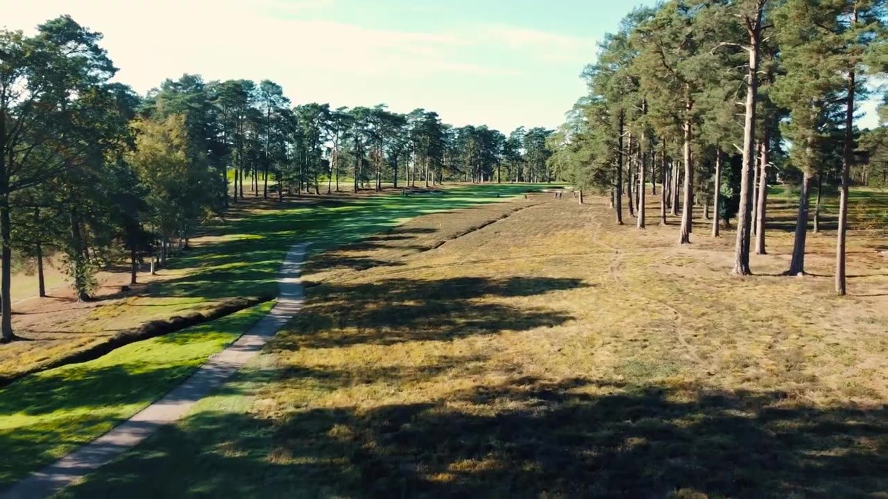 Aerial view of a heather-lined fairway at Worplesdon Golf Club